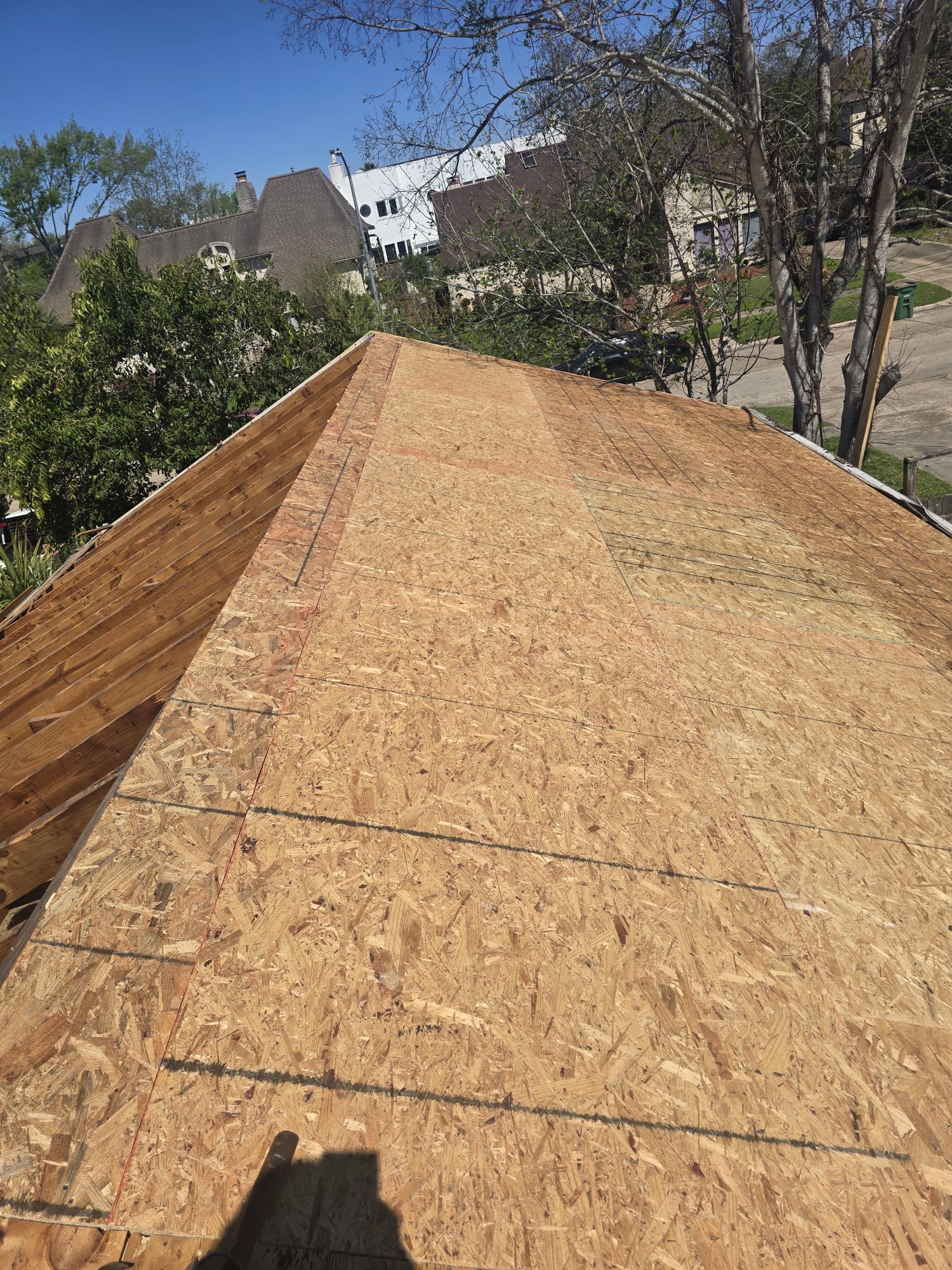 Timber sheathing boards fixed over roof framing.